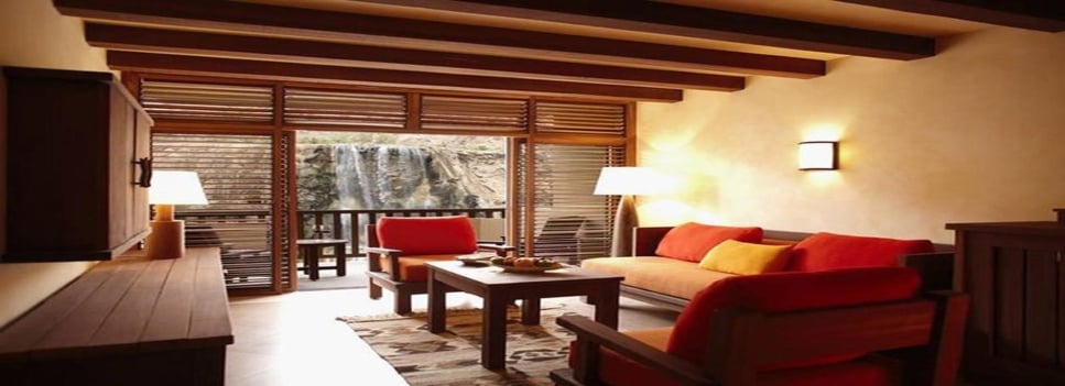 Guest suite living area with a balcony view at Ma’in Hot Springs Resort and Spa