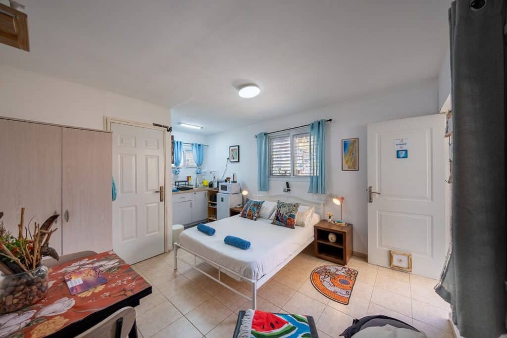 Guest room with a double bed and kitchenette