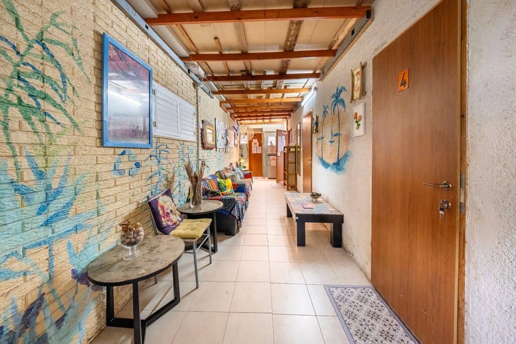 Covered corridor with painted walls and guest room doors