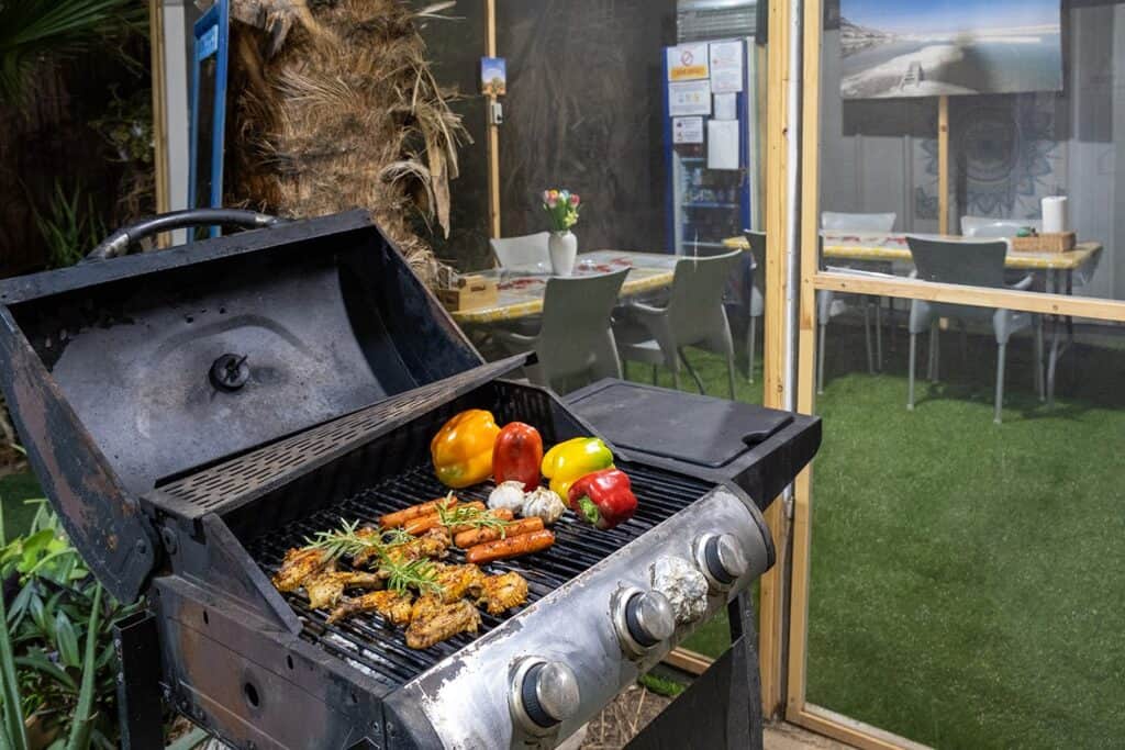 Gas barbecue beside outdoor seating at the guesthouse