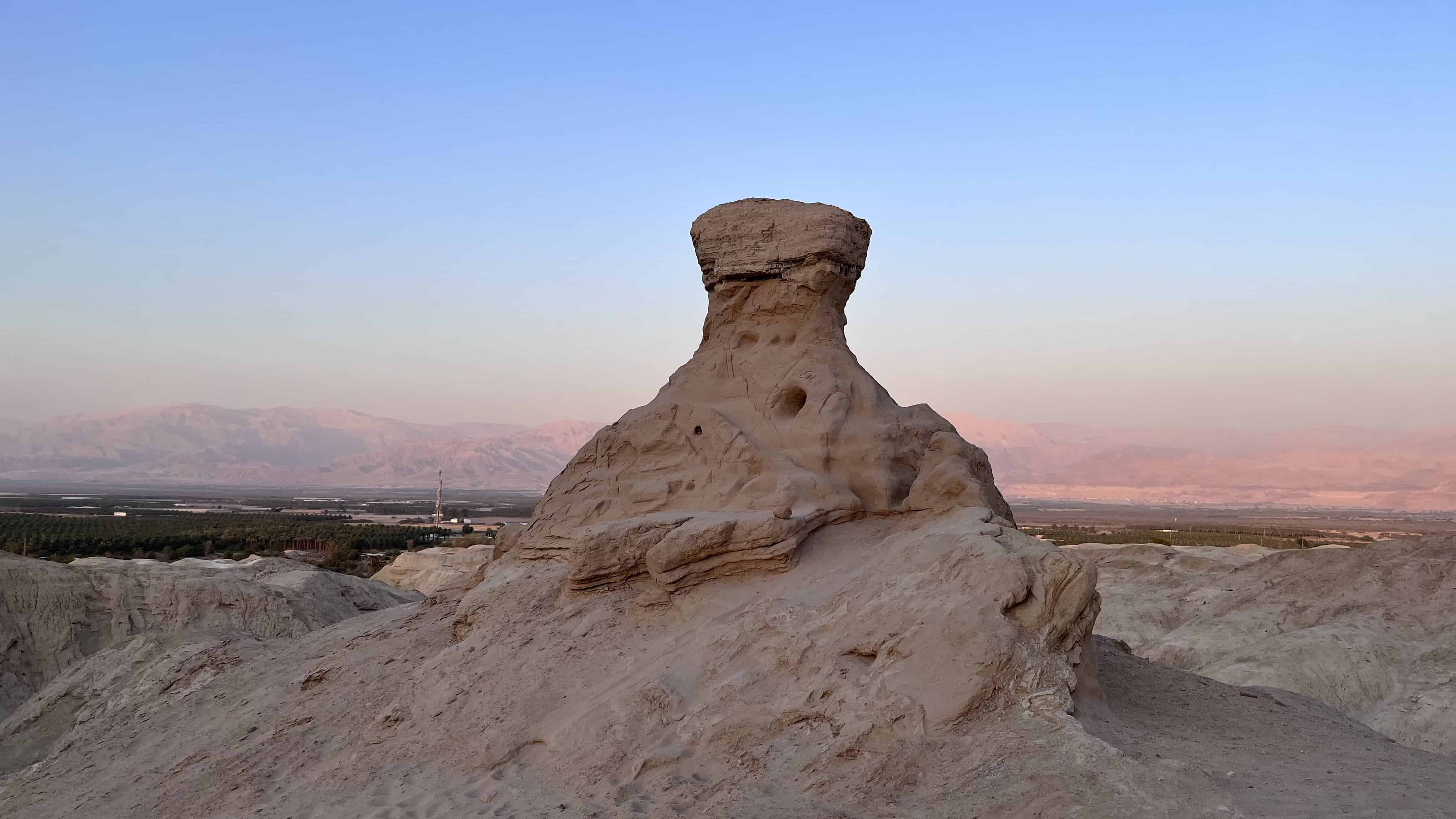 Mushroom-shaped rock formation in a desert landscape outside the guesthouse