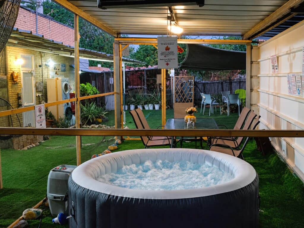 Round hot tub and seating in the covered guesthouse courtyard