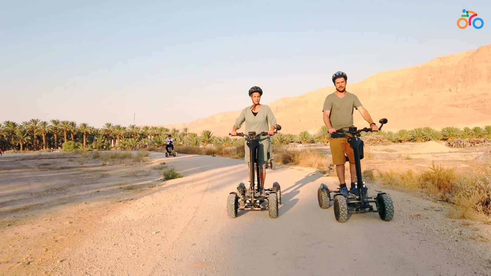 Two electric riders on a desert route